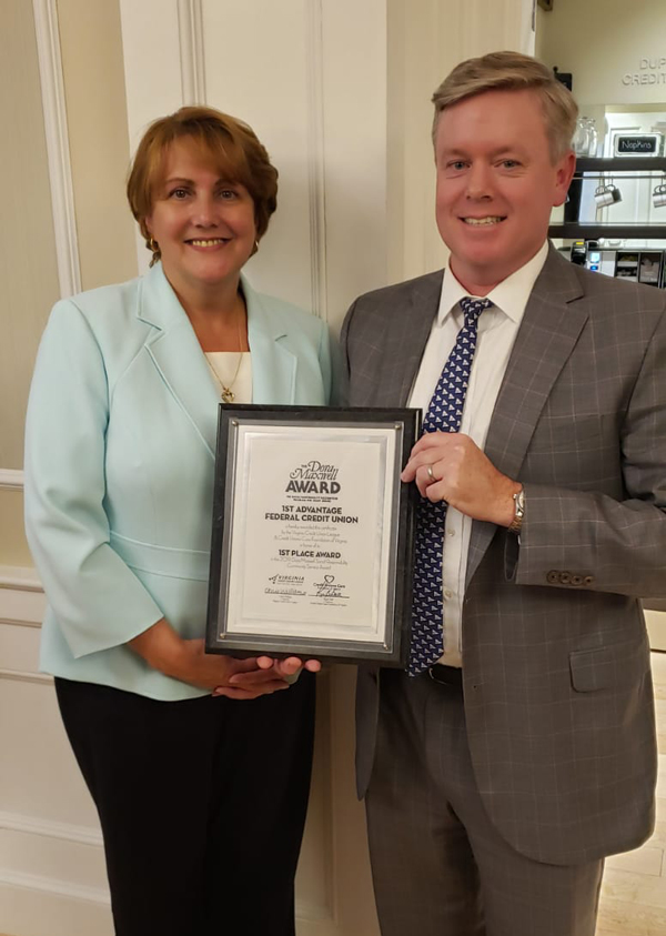 Michelle Nealey, Chief Financial Officer of 1st Advantage and Paul W. Muse, President and CEO of 1st Advantage accepting the credit union's Dora Maxwell Award